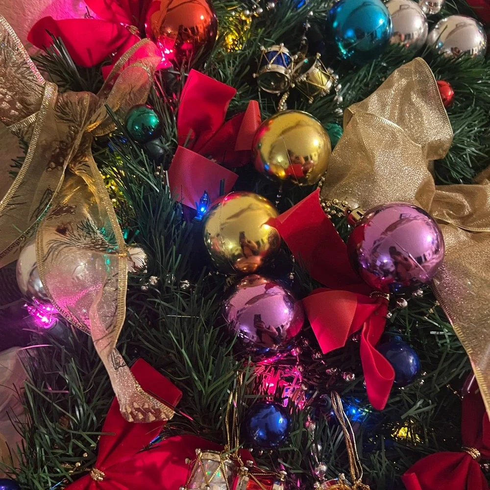 Festive Holiday Wreath with Gold Bow and Multicolor Ornaments